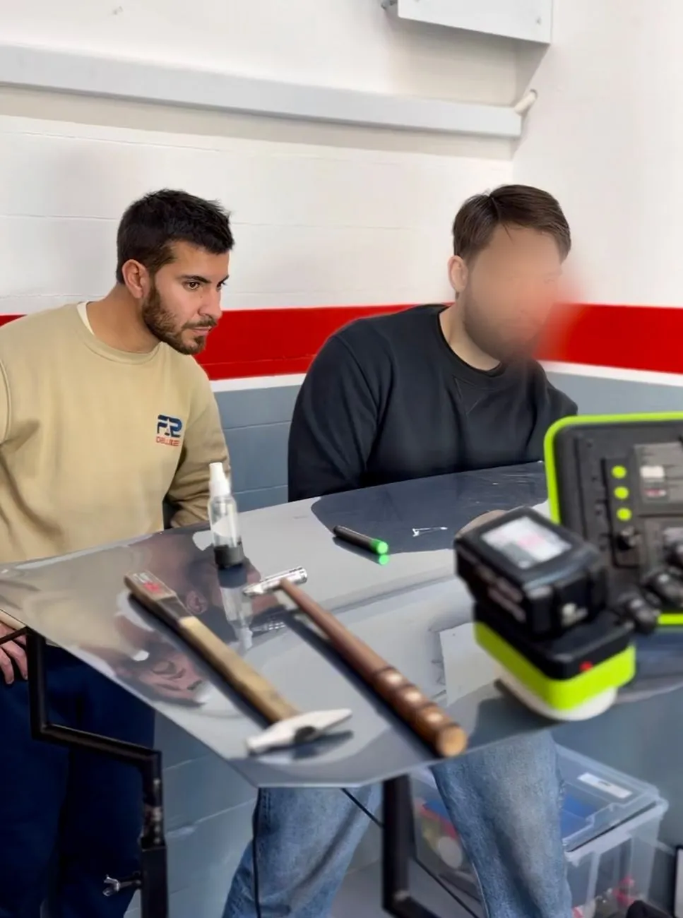 Federico explicando técnica PDR detallada a un alumno durante su curso de varillero en Barcelona